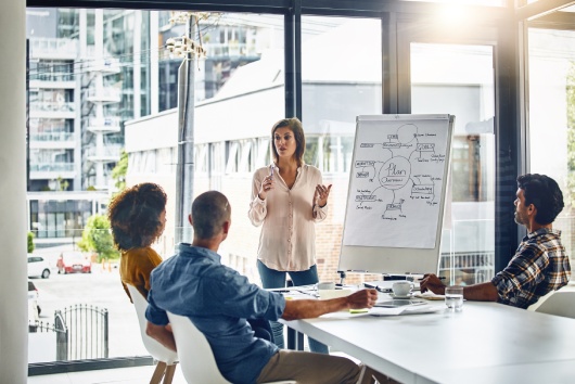 Presentation, whiteboard and woman for meeting with colleague, office and corporate for planning. Speaker, project and communication for financial advisor people, charts and data for sales discussion