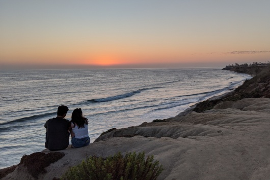 South Carlsbad sea cliff sunset - Southern California coastal scenes with waves on pristine deserted beaches, sunsets and silhouettes, tide pools,  and palms trees with surfers riding waves.
